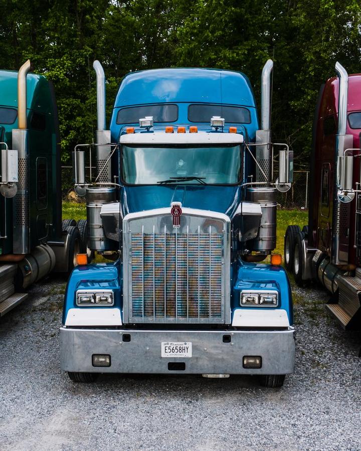 Three semi tractors parked side by side